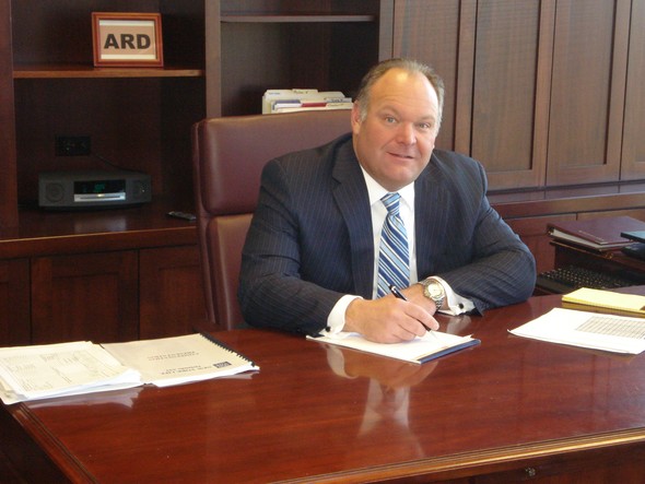 Trent at his desk working on paperwork